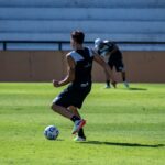 A soccer player training on a sunny day, showcasing agility and skill.