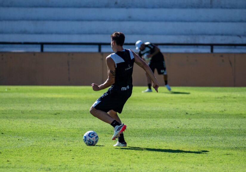 A soccer player training on a sunny day, showcasing agility and skill.
