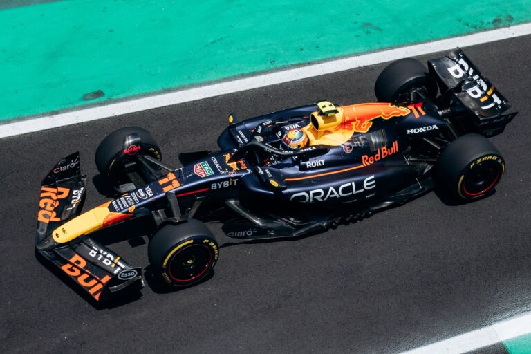 High-speed Formula 1 car on track from an aerial perspective highlighting dynamic racing action.