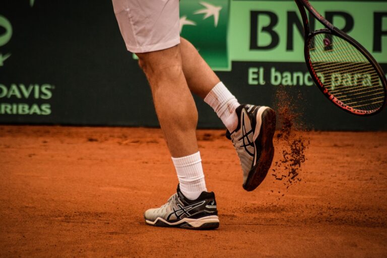 Close-up of a tennis player on a clay court in Montevideo, showcasing movement and energy.