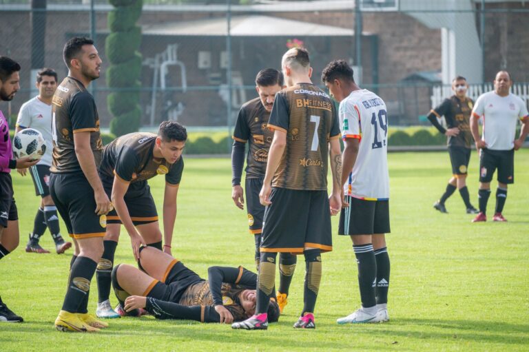 Players gather around an injured teammate during a soccer match in Texcoco, Mexico.