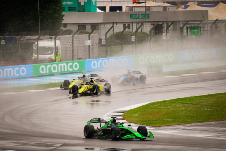Exciting Formula 1 race on a wet track showcasing high-speed dynamics.