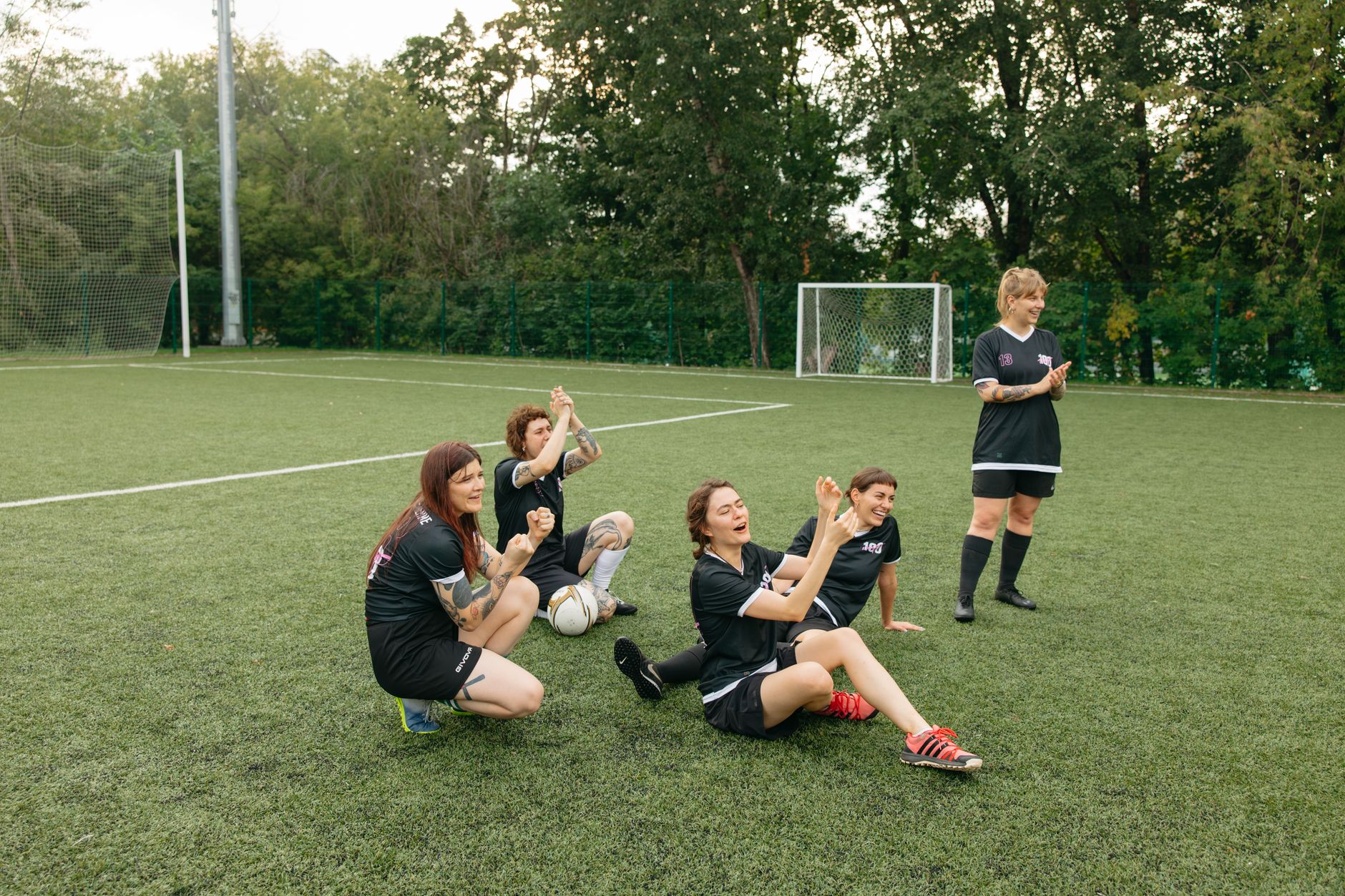 A women's soccer team celebrating joyfully on the field. Team spirit and sportsmanship.