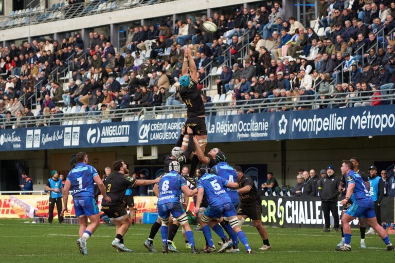 Exciting rugby match with crowds cheering at a stadium in Montpellier, Occitanie, France.