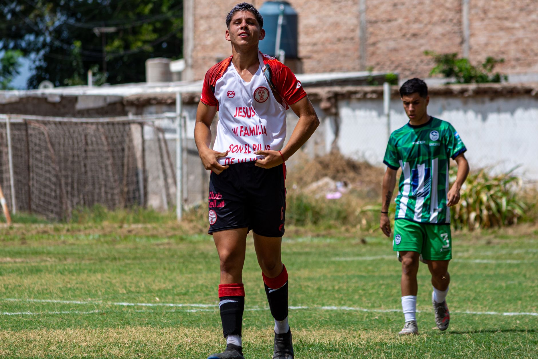 Two young soccer players in action on a sunny outdoor field.