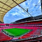 A stunning view of the iconic Wembley Stadium in London, capturing its vastness and architectural beauty.