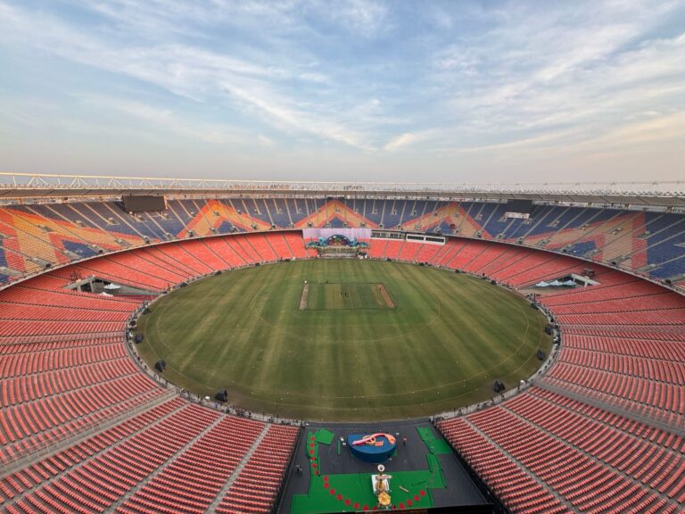 Wide-angle aerial view of the iconic Narendra Modi Stadium in Ahmedabad, India, at day.