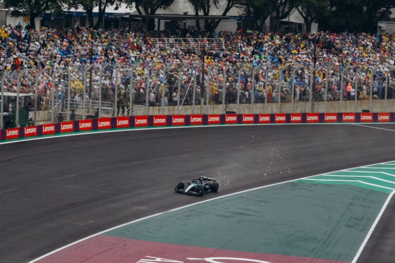 High-adrenaline moment captured during a Formula 1 race with a packed audience.