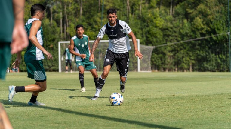 Players in action during an outdoor soccer match, showcasing athletic skills.
