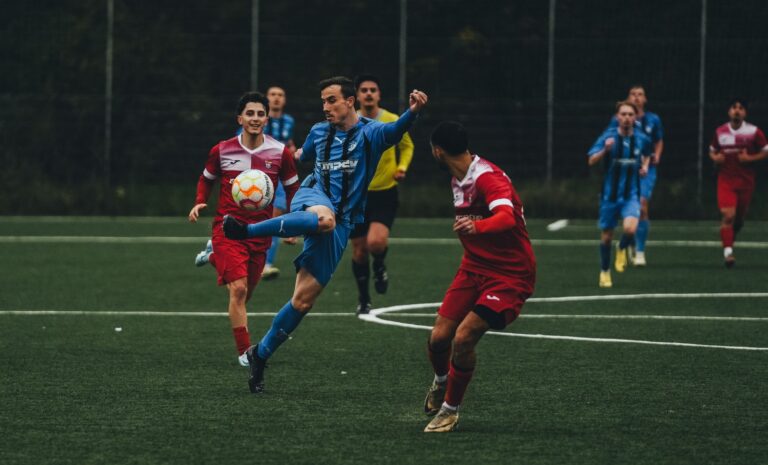 Players in action during a competitive football match on an outdoor field.