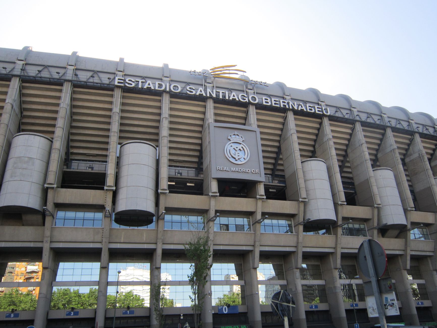 Impressive view of the iconic Santiago Bernabéu Stadium in Madrid, Spain, captured during a bright summer day.