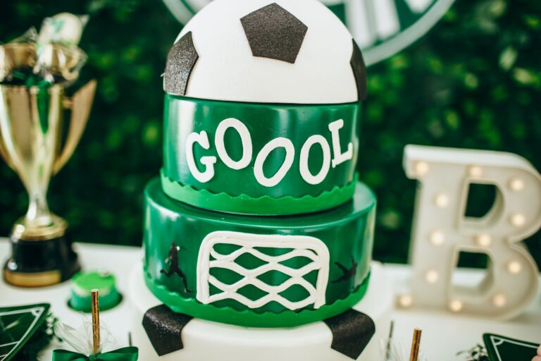 Celebrate in style with a soccer-themed cake featuring a trophy and decorative accents.