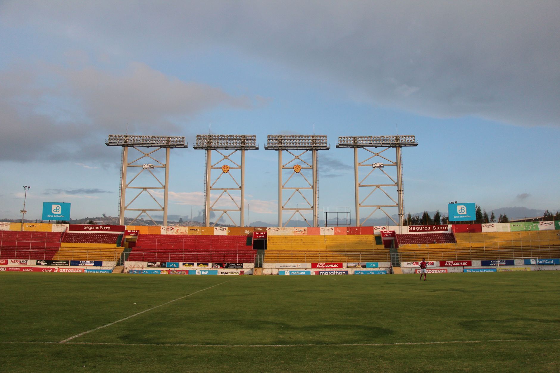 Wide view of Gonzalo Pozo Ripalda Stadium in Quito, Ecuador. Captures the peaceful atmosphere of an empty soccer field.
