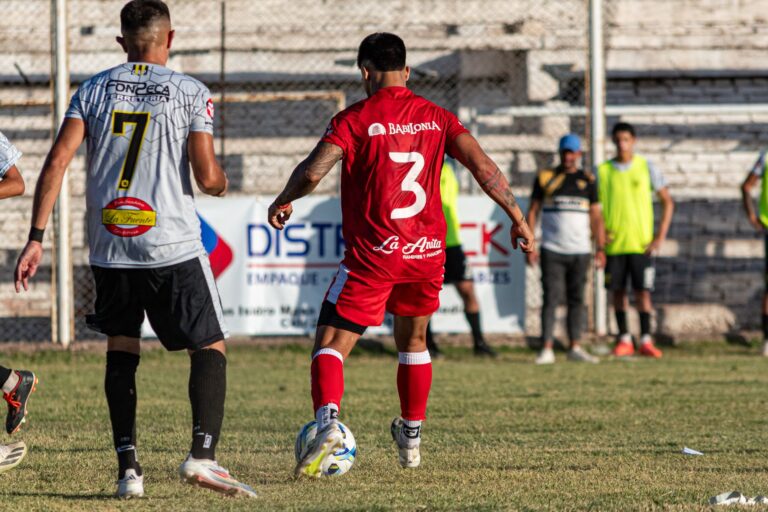 Soccer players in a dynamic match, showcasing teamwork and competition.