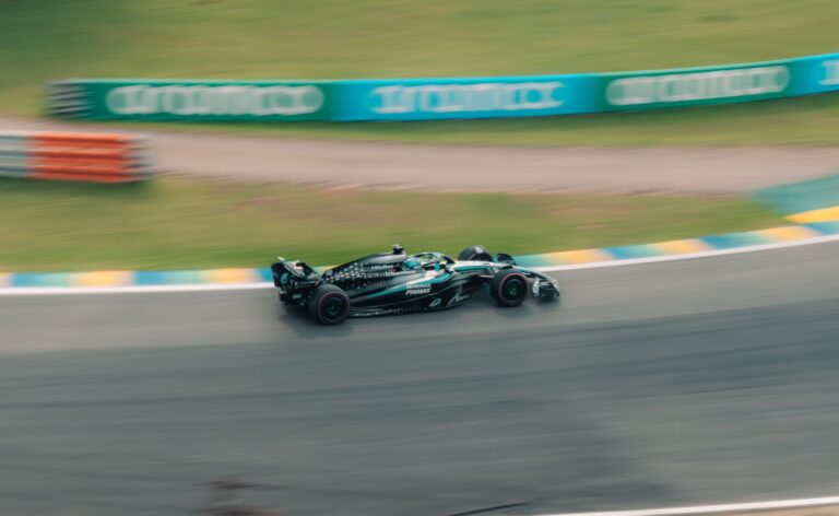 A race car spearing down a track in São Paulo, Brazil, showcasing speed and motion.