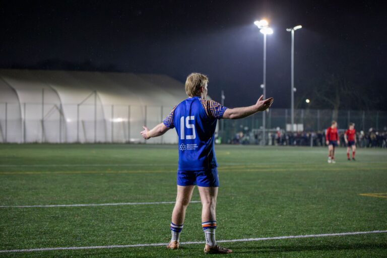 Rugby player expressing frustration during a night match in England, UK.
