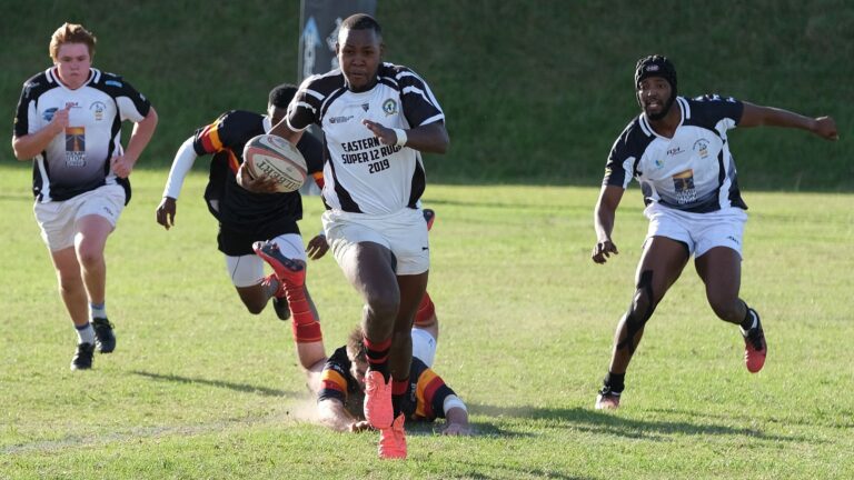 Dynamic rugby match with diverse players sprinting on a sunny day in South Africa.