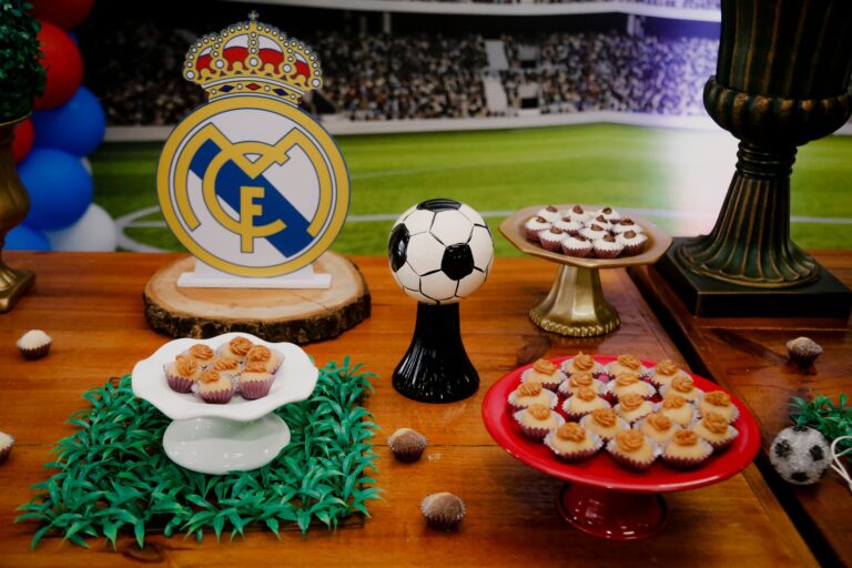 Dessert table with cupcakes and football theme, perfect for parties.