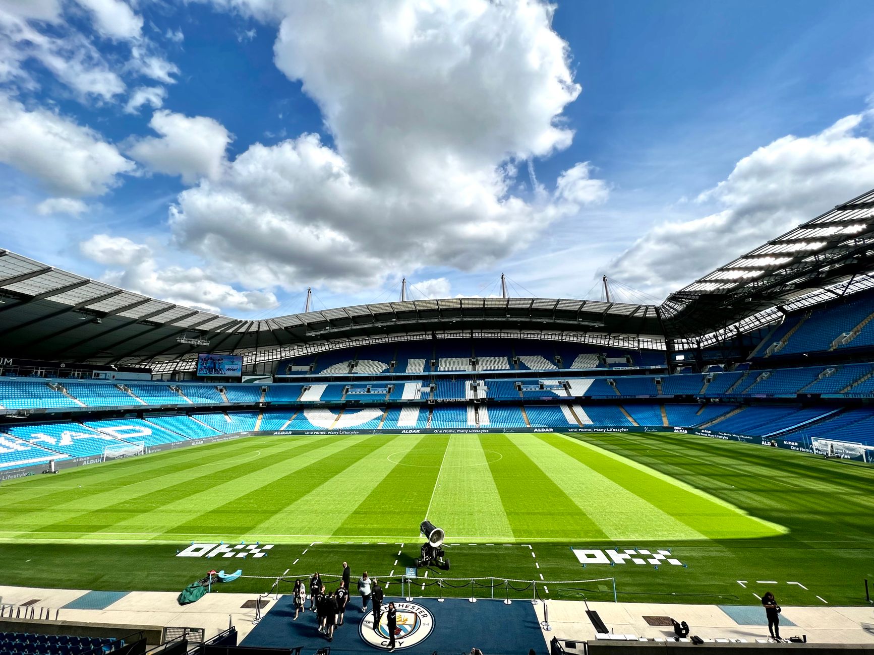 A view of the iconic Etihad Stadium in Manchester, United Kingdom, showcasing its vibrant football field.
