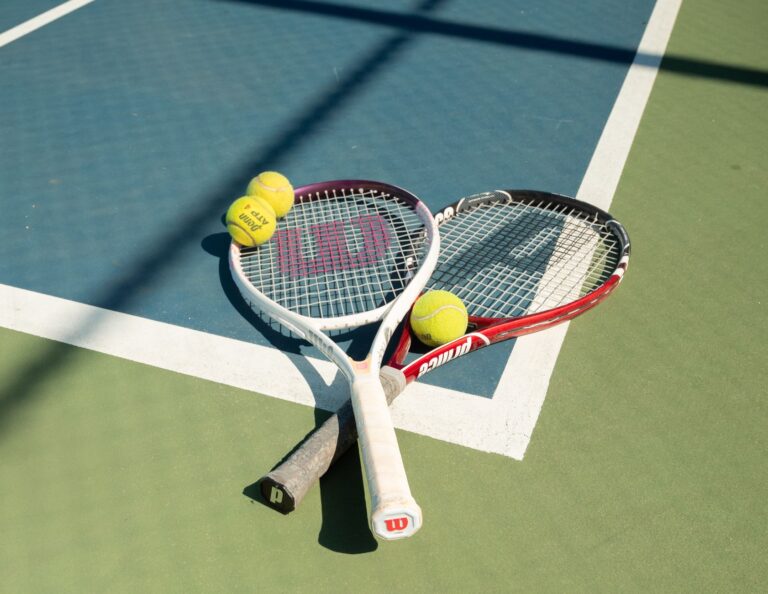 Tennis rackets and balls on a sunny outdoor court in San Francisco.