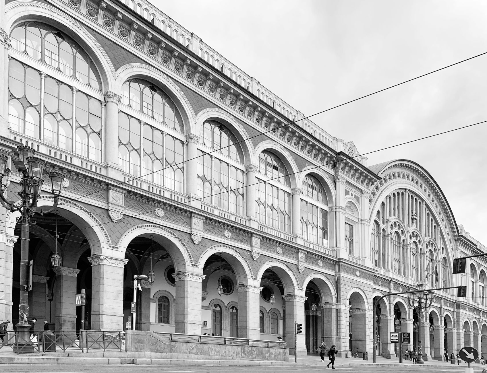 Black and white photo of historic building in Torino, showcasing architectural details.