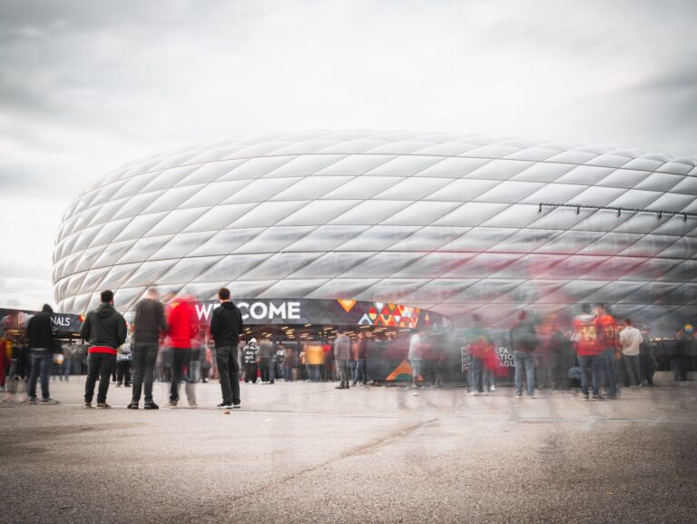 Fans gathering outside Allianz Arena in Munich, Germany, ready for a soccer event.