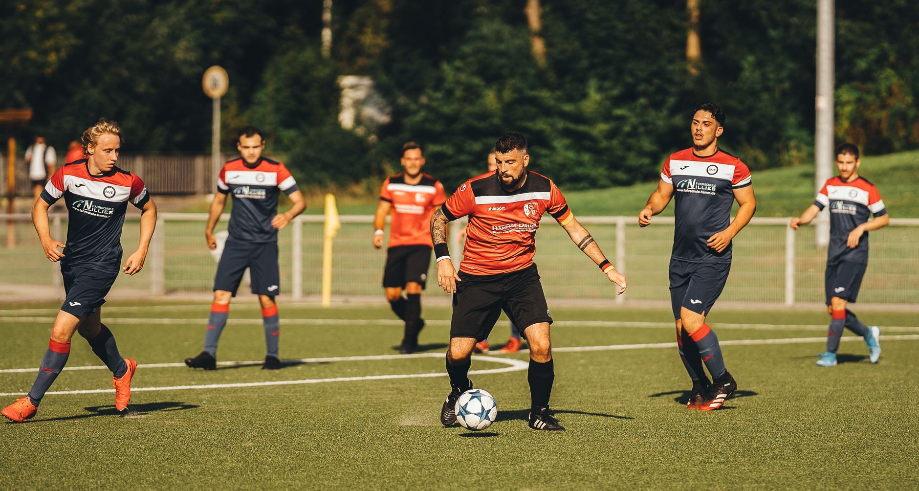 Group of diverse soccer players in action on the field during a lively match.