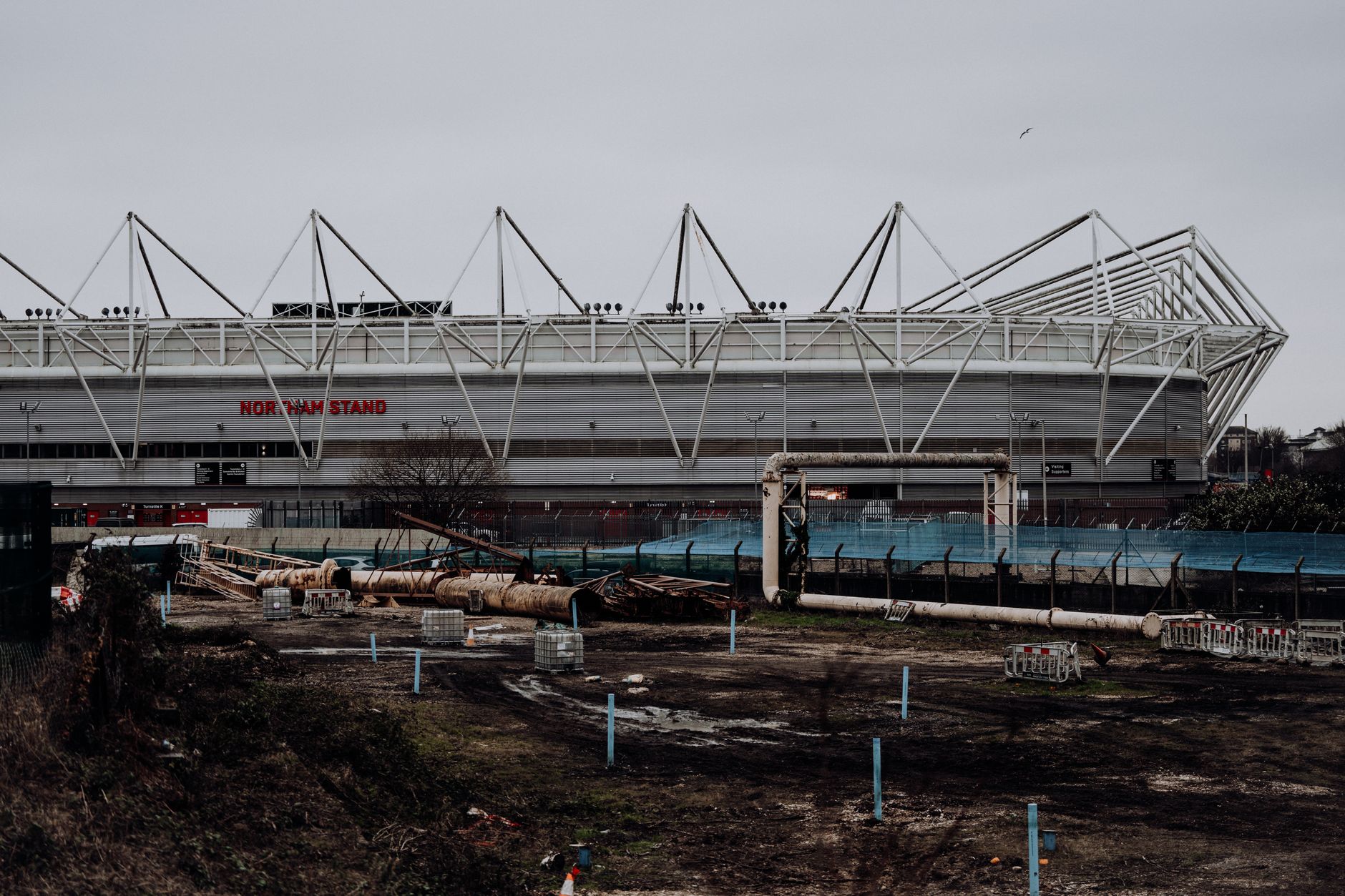 View of St Mary's Stadium's Northam Stand, Southampton across a construction site.