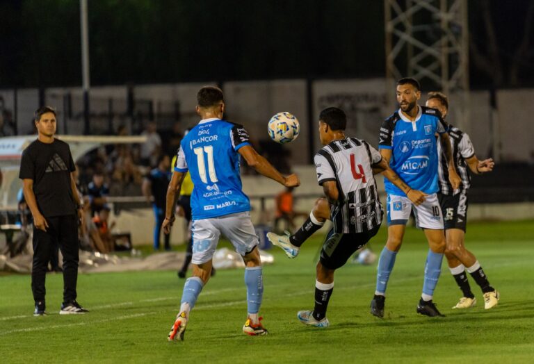 High-energy soccer match under stadium lights showcasing player dynamics and sports energy.