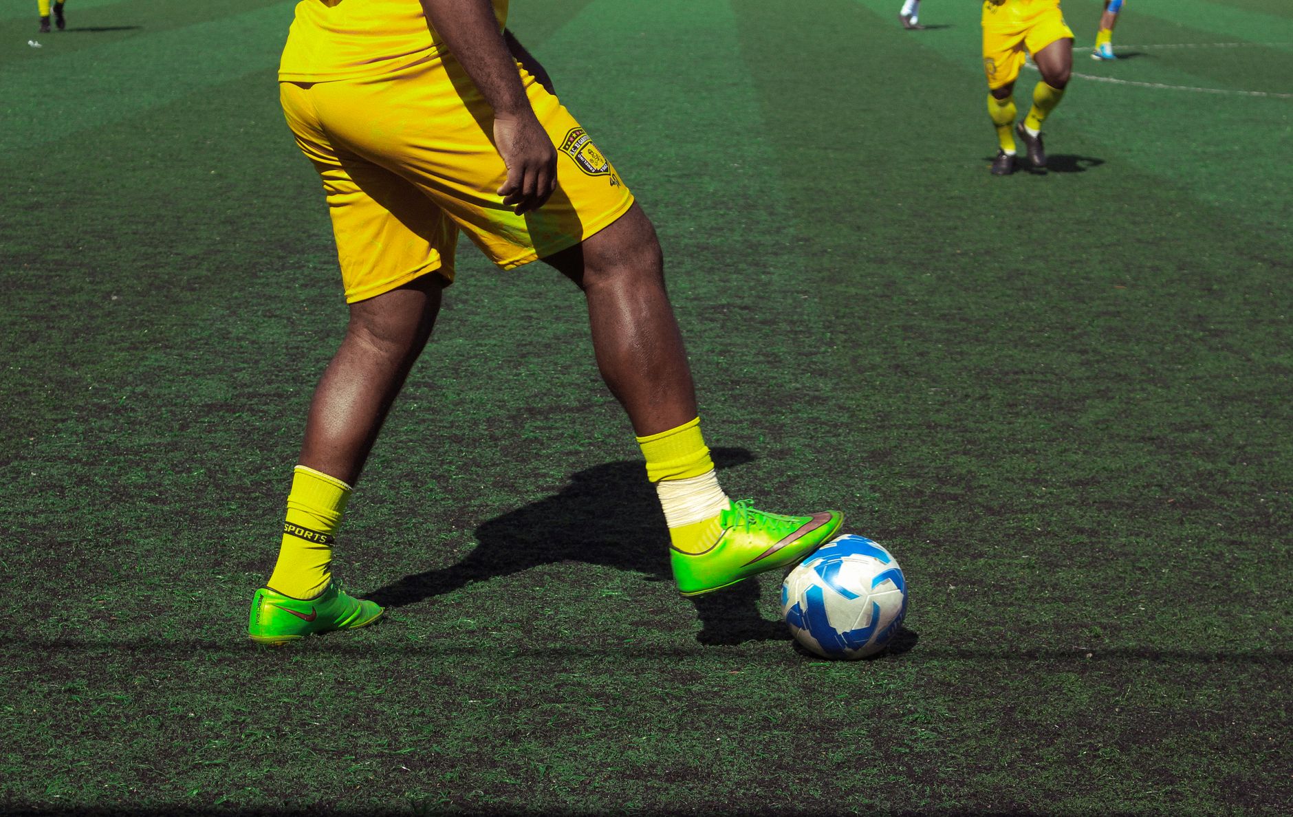 Dynamic image of soccer players in action on a football field in São Paulo, Brazil.