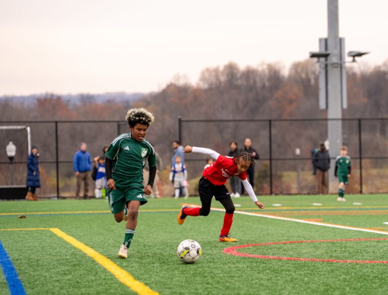 Exciting youth soccer match in Maryland, showcasing young athletes in action on a vibrant field.