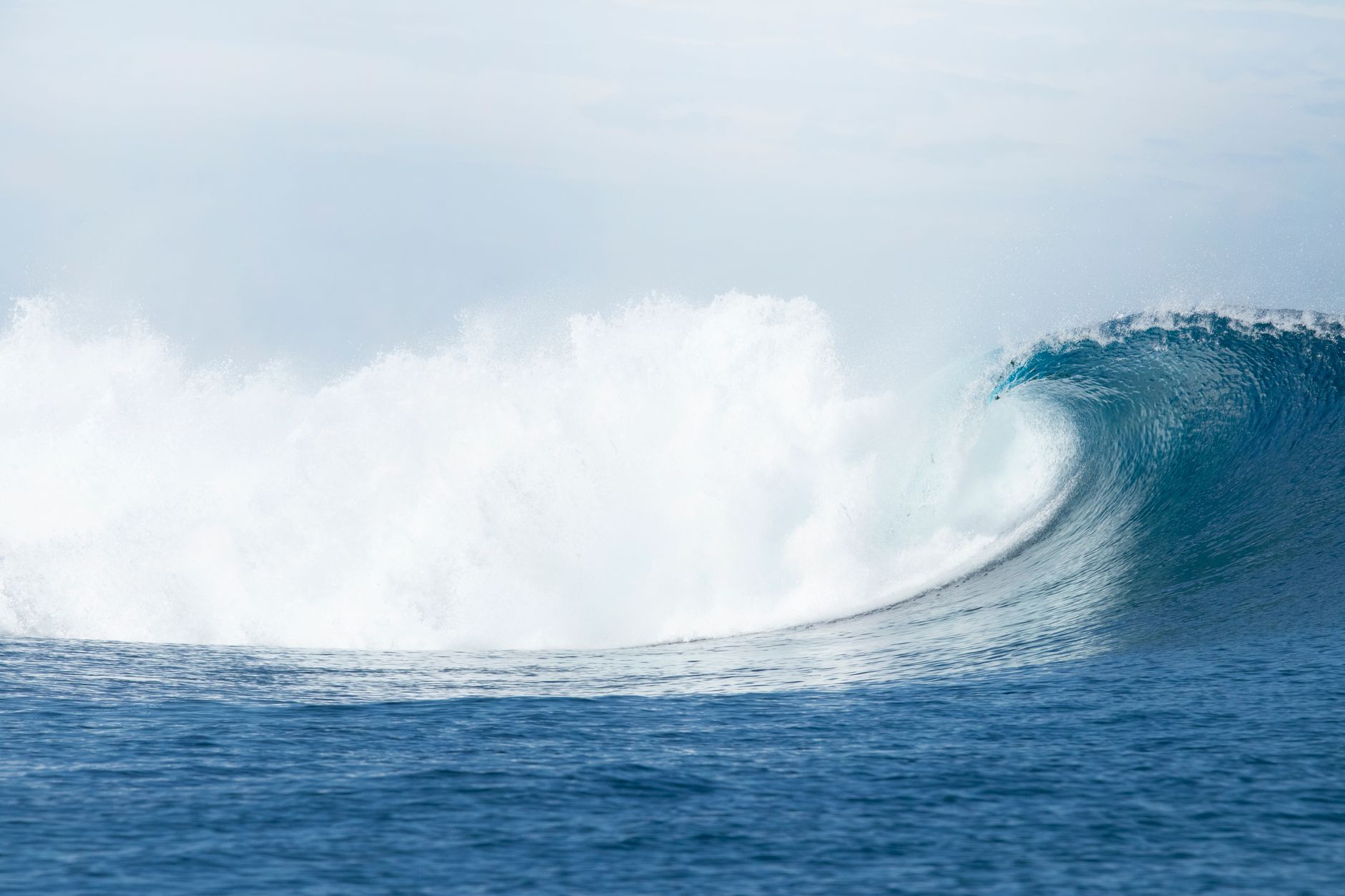 A stunning ocean wave crashing majestically, captured off the coast of Fiji, showcasing nature's beauty.