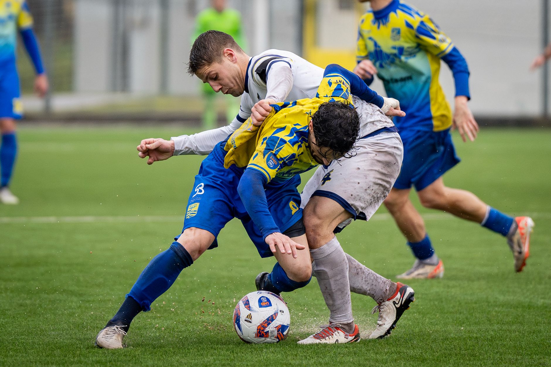 Close-up action shot of two soccer players tackling during an intense match.