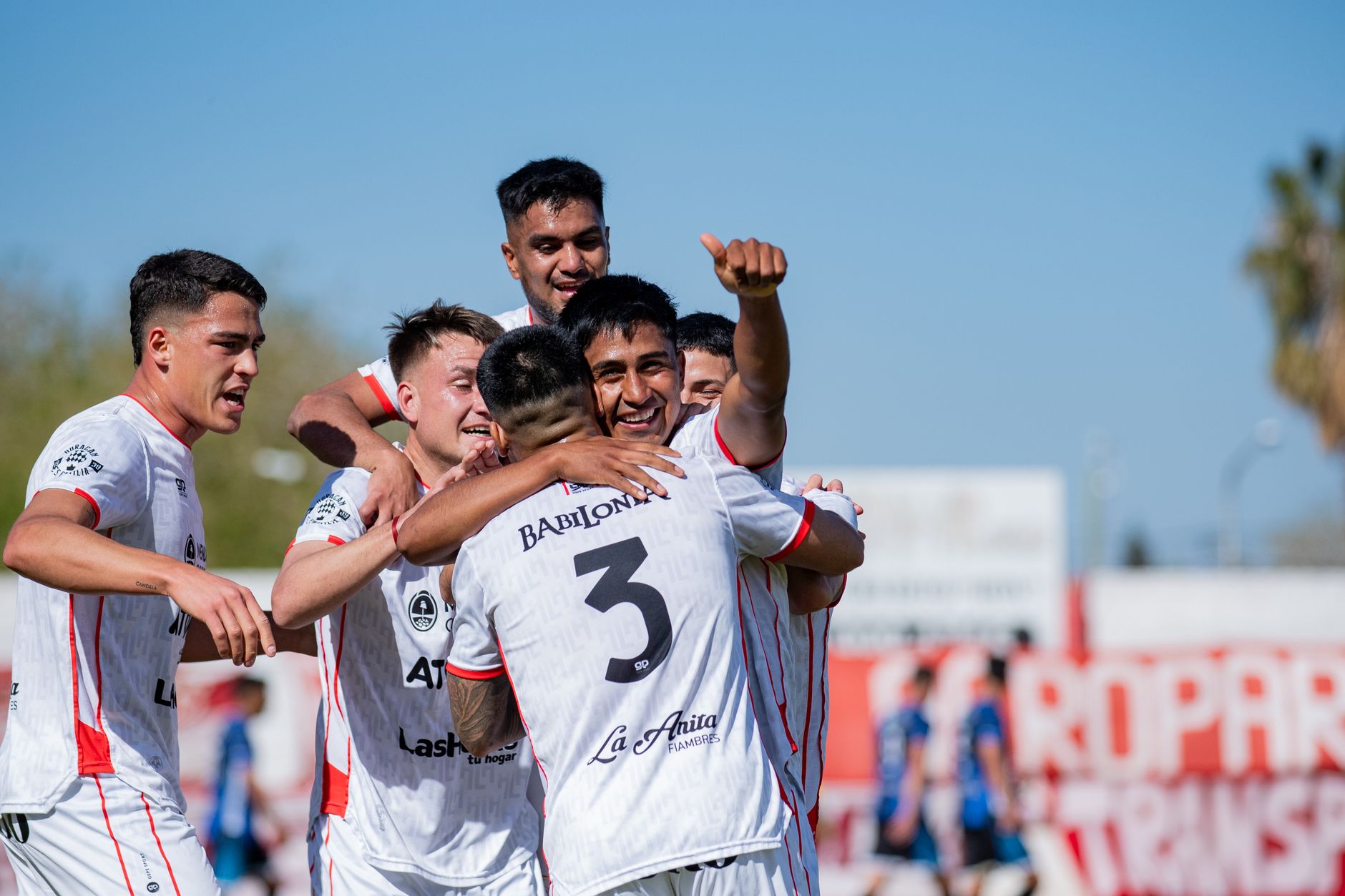 A joyful soccer team celebrating a victory outdoors, showing sportsmanship and unity.