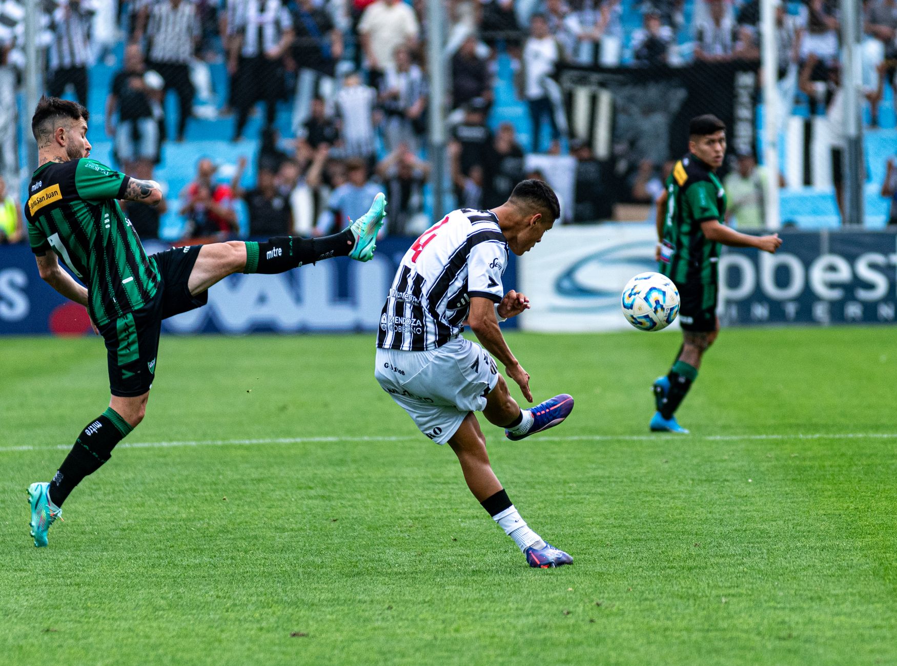 Action-packed soccer game with players competing vigorously on a green field.