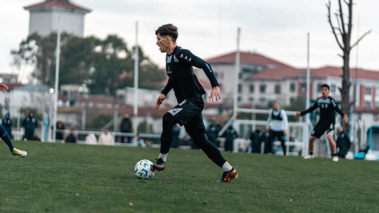 Talented young soccer player dribbling during a match on a sunny day.