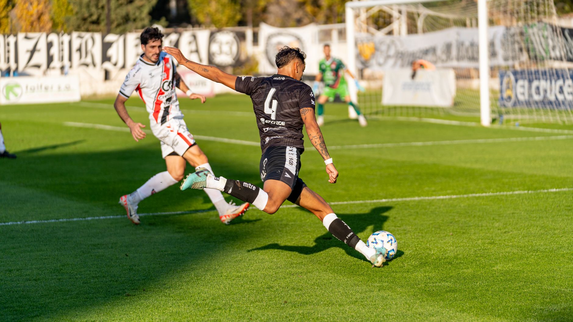 Exciting soccer game capturing players in mid-action on the field during a sunny day.