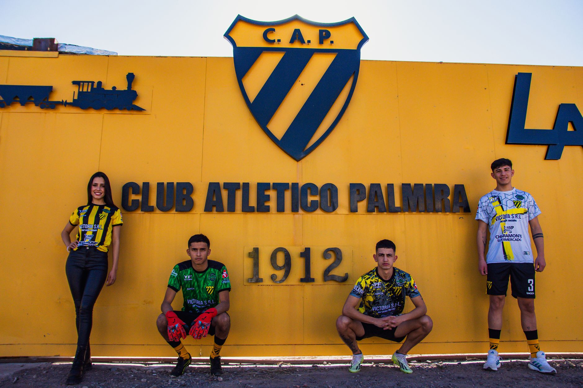 Members of Club Atletico Palmira posing proudly in team apparel.