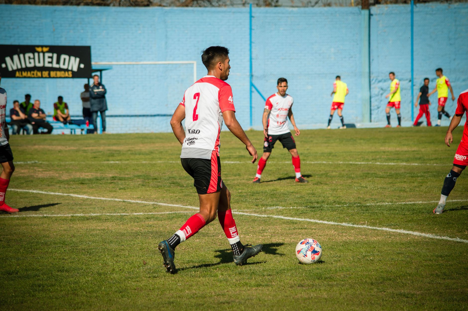 Action-packed soccer game in Mendoza, featuring diverse players on a vibrant field.