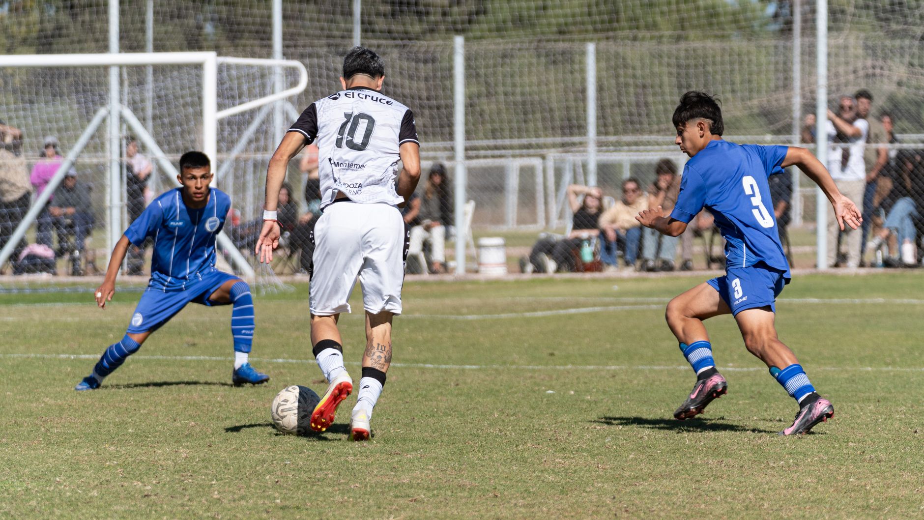 Dynamic action shot capturing players during a competitive soccer match outdoors.
