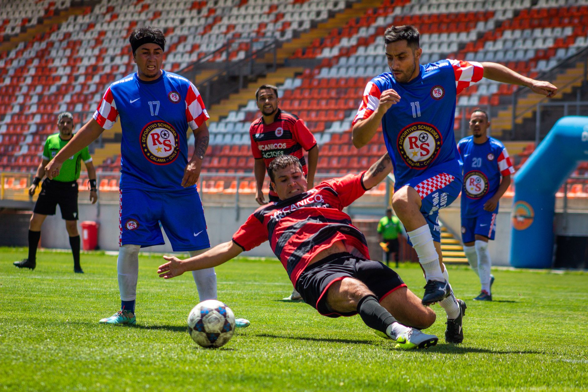 Exciting soccer match with players in motion during bright daylight. Capture of teamwork and sportsmanship on the field.