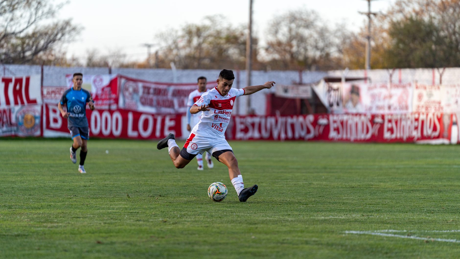 Soccer player in motion during a match, capturing the intensity of the game.