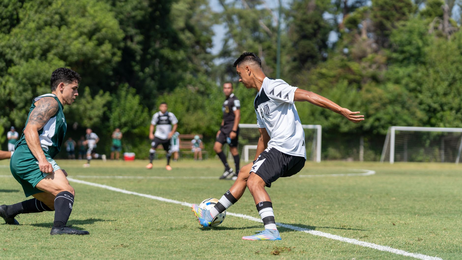 Dynamic moment captured during an outdoor soccer match between two teams.