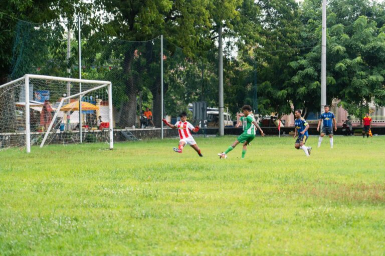 Action-packed moment in a youth soccer match on a sunny day.