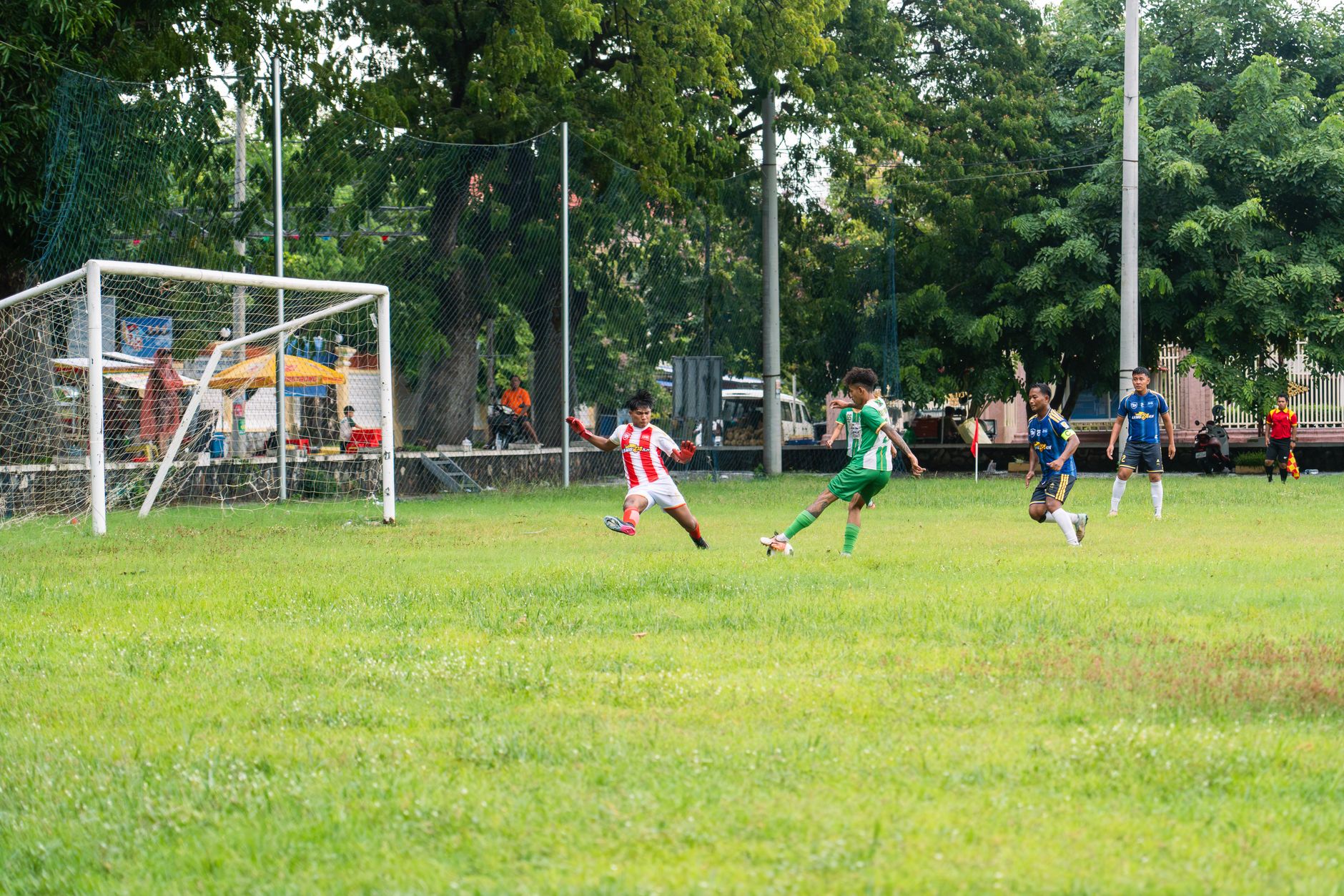 Action-packed moment in a youth soccer match on a sunny day.