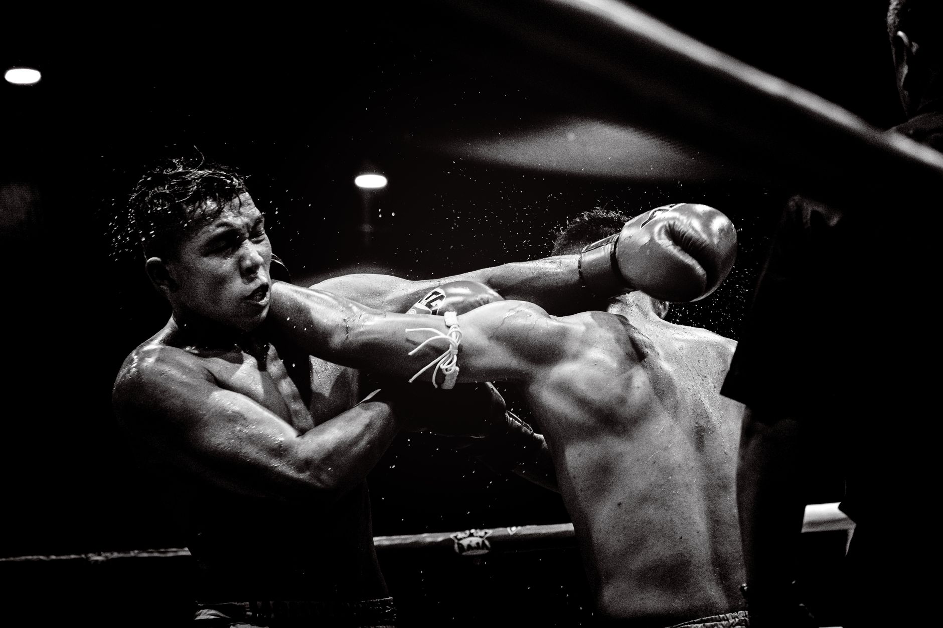 Dynamic black and white photo capturing a powerful moment in a boxing match.