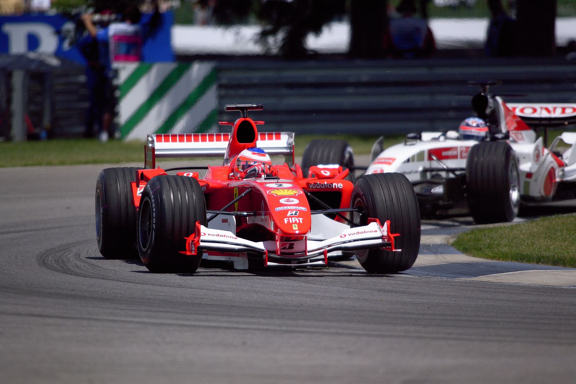 Thrilling Ferrari and Honda Formula 1 race at Indianapolis, showcasing motorsport excitement.