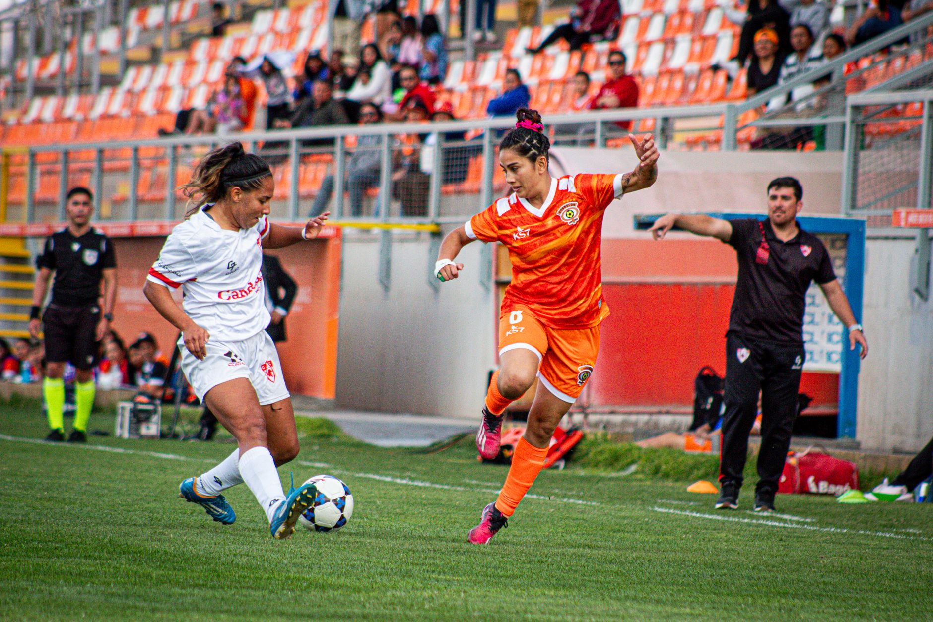 Captivating action from a women's soccer match in Chile, showcasing athletic skill and team spirit.
