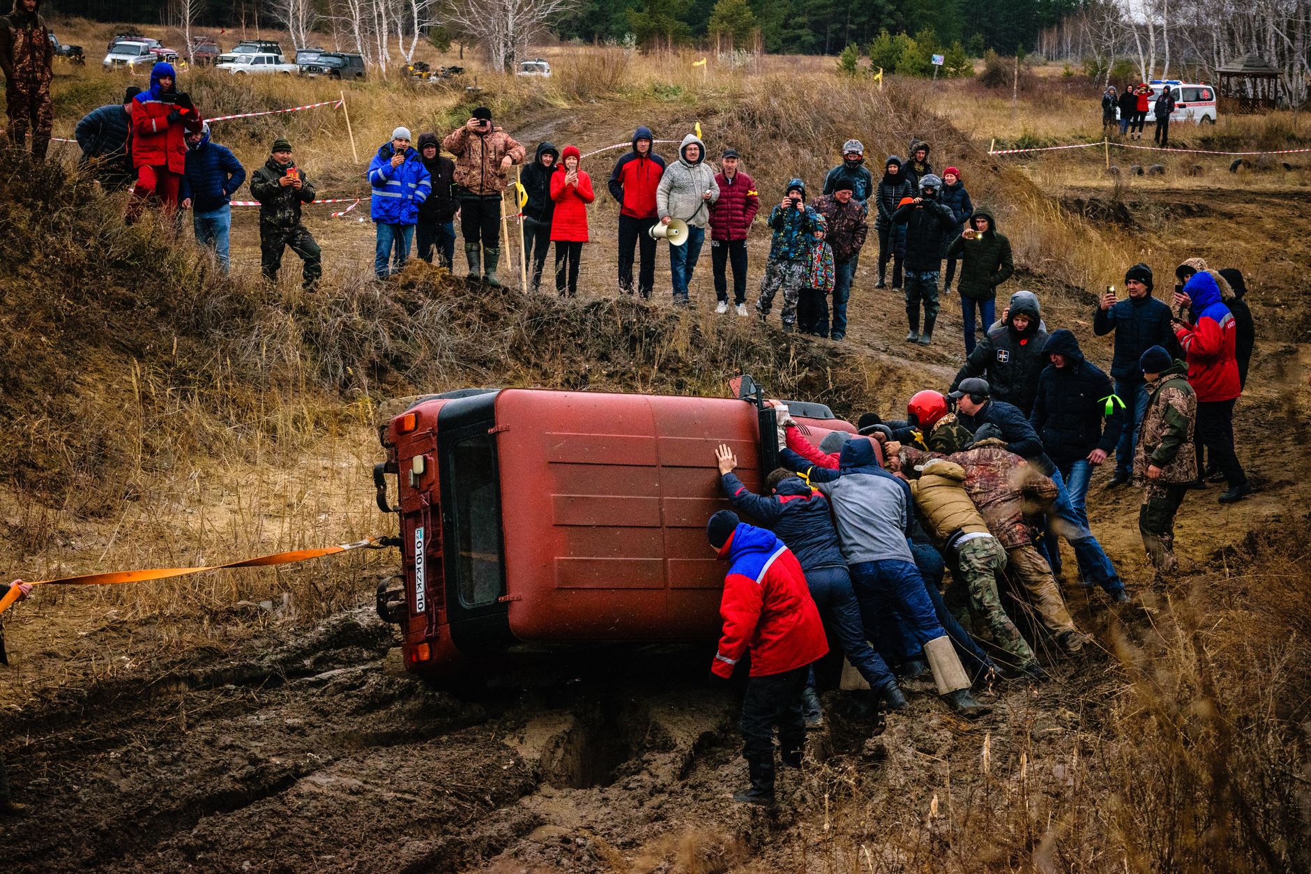Group efforts to recover a flipped vehicle during an offroad race in Kazakhstan.