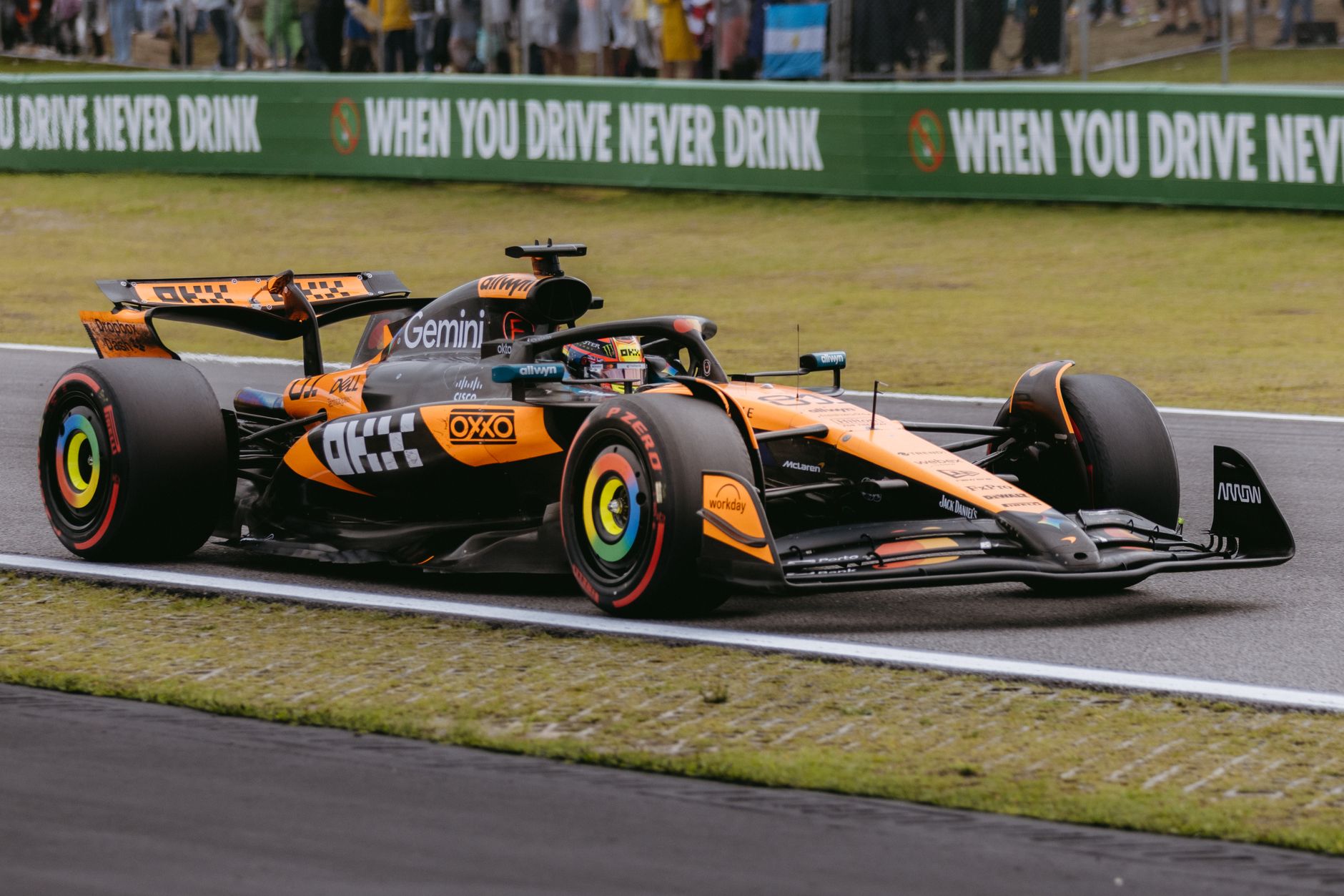 Orange and black F1 car racing on track in São Paulo, Brazil, during the Grand Prix.